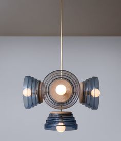 a light that is on top of a metal object with two lights hanging from it