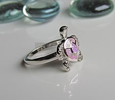 Lab Pink Opal ring - Opal turtle silver ring - Turtle ring - womens silver ring - cute ring - turtle lover Some sizes are sold out. But will be replenished shortly Height of ring is 16.7mm and width is 14.4 Band width 2.4mm and shank is 2.4mm This is a Lab Opal created stone in an inlay setting High Polished, solid 925 sterling silver. Rhodium plated to prevent tarnishing. TARNISH FREE Rhodium plated to avoid tarnishing Nothing but the best from my custom jewelry store. If it doesnt fit, you hav Silver Turtle Jewelry, Sterling Silver Turtle-shaped Rings, Pink Opal Ring, Turtle Ring, Star Labs, Cute Ring, Vero Beach Fl, Ring Opal, Vero Beach