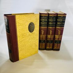 three books sitting next to each other on a table