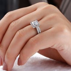 a woman's hand with a diamond ring on it