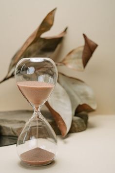 an hourglass sitting on top of a white table