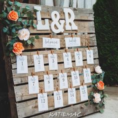 a wooden calendar with flowers and greenery on it