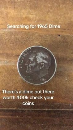 an image of a coin on top of a wooden box with the words searching for 1965 dime