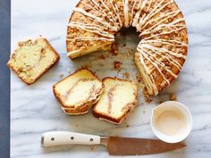 a marble table topped with slices of cake next to a knife