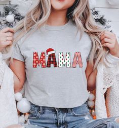 Mama Christmas Shirt, Mom Shirt, Mama Shirt, Gift for Mom, Christmas Gift, Holiday Shirt, Cute Mama Christmas Shirt, Christmas Mama T-shirts are Bella + Canvas 3001 Unisex * Solid colors are 100% combed and ring-spun cotton (heather colors contain polyester) * Fabric weight: 4.2 oz/yd² (142 g/m²) * Pre-shrunk fabric * Side-seamed construction * Shoulder-to-shoulder taping SIZING All products are unisex sizes and not women's fitted shirts - if you prefer a fitted look, we suggest sizing down.  Pl Holiday Short Sleeve Shirt With Letter Print, Festive Short Sleeve Shirt With Letter Print, Winter Gift Shirt With Letter Print, Winter Letter Print Shirt For Gift, Winter Letter Print Shirt Gift, Casual Letter Print Tops For Festive Occasions, Christmas Letter Print Cotton Tops, Christmas Festive Tops With Letter Print, Festive Christmas Letter Print Tops