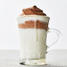 a glass cup filled with whipped cream and chocolate