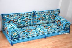 a blue couch sitting on top of a hard wood floor