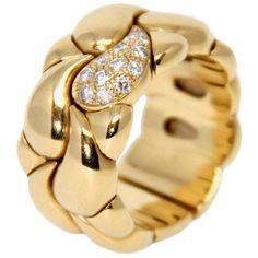 This exquisite ring from Chopard is part of the Casmir collection. It is made of 18K yellow gold and set with pave round briliant cut diamonds. Its design is a succession of geometric pattern in the style of drops ! Metal: 18K gold, diamond Size: 57.5 Height: 1.2 cms Weight: 24.84 gr Condition: Very good Ref: 9319498 82 / 1546 - 43 Made in Switzerland All items at la Bourse du Luxe are subject to a strict quality control Chopard Jewelry Rings, Gold Thumb Rings, Yellow Gold Diamond Ring, Semi Precious Jewelry, Thumb Rings, Diamond Sizes, Quality Control, Cocktail Rings, Gold Ring