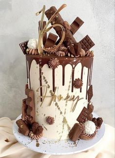 a birthday cake with chocolate decorations and the number six on top