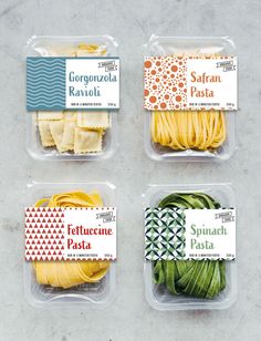 four plastic containers with different types of pasta in them on a gray surface, each containing an individual's name