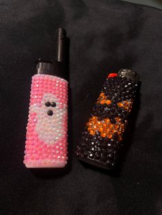 two lighters with different designs on them sitting next to each other