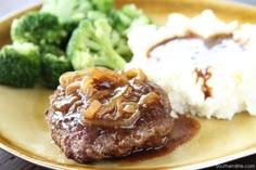 meatloaf, mashed potatoes and broccoli on a plate with gravy