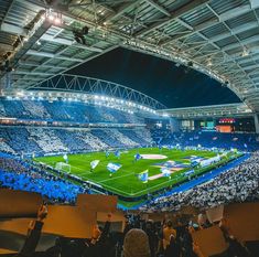 a large stadium filled with people holding signs