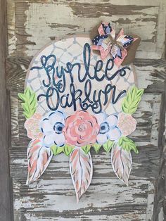 a sign that says, burle's garden with flowers and leaves on it