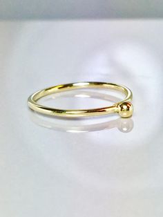 Cute and Dainty solid gold droplet ring Great for baby/children and adults fingers Very sparkly Pave diamond cut or smooth polished finish. **Gold: 14k/10k Real Solid Gold **Thickness approx : 1.0mm **Droplet size: 2.0mm Sturdy and well designed and great for any occasion. **Order yours Today! Minimalist 14k Gold Teardrop Ring, Gold Stackable Toe Birthstone Ring, Gold Stackable Toe Ring Birthstone, Everyday Simple Gold Birthstone Ring, Gold Birthstone Ring In 14k With Simple Design, Gold Teardrop 14k Gold Ring, Tiny Gold Birthstone Ring With Round Band, Adjustable Yellow Gold Teardrop Rings, Adjustable Teardrop Yellow Gold Ring