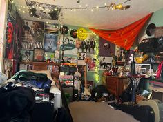 a cluttered room with many items on the wall and decorations hanging from the ceiling