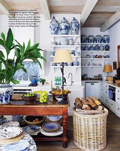 the kitchen is decorated with blue and white dishes, bread baskets, vases and other items