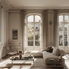 a living room filled with furniture and large windows