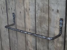 an old metal handle on a wooden wall