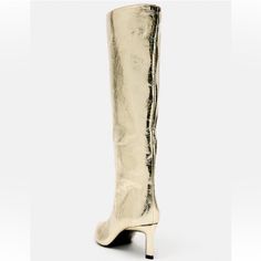 High-Heel Boots With A Metallic Effect. Pointed Toe. Heel Height: 6.5 Cm. / 2.5″ Gold Pointed Toe Knee-high Boots For Party, Gold Heeled Boots With Reinforced Heel And Round Toe, Party Knee-high Boots With Square Toe And Reinforced Heel, Party Knee-high Boots With Reinforced Heel And Square Toe, Gold Boots For Spring Evening, Gold Evening Boots For Spring, Glamorous Gold Heeled Boots For Evening, Chic Gold High Heel Knee-high Boots, Gold Knee-high Evening Boots