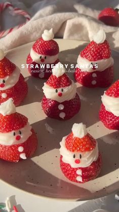 strawberry santas are arranged on a plate