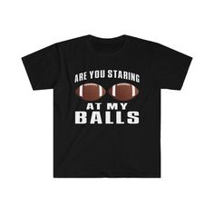 a black t - shirt that says are you staring at my balls on the front