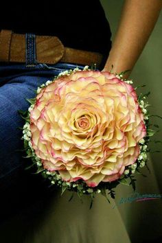 a person holding a bouquet of flowers in their lap