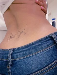 a woman's stomach with the word star girl written on her lower back side