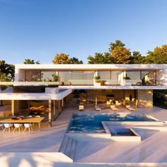 an aerial view of a modern house with pool and outdoor dining area in the foreground