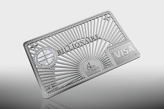 a silver credit card sitting on top of a reflective surface with the word visa printed on it