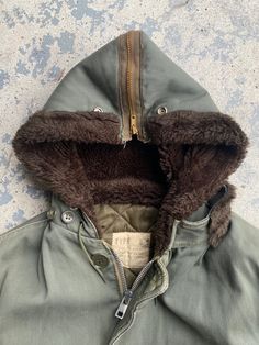 Vintage 50s B-9 Parka Flight Military Split Hood Jacket Perfect condition no flaws at all. Heavyweight quilted lined and warm. So many good details on this thing. 23 inch pit 31 inch length 20 1/4 inch shoulders 17 1/4 inch sleeve from pit Vintage Parka With Detachable Hood For Streetwear, Vintage Hooded Outerwear With Pockets, Vintage Outerwear With Detachable Hood For Streetwear, Vintage Brown Outerwear With Zip Fly, Vintage Hooded Parka With Pockets, Vintage Hooded Jacket With Detachable Hood For Streetwear, Vintage Hooded Outerwear For Outdoor, Vintage Parka With Pockets For Cold Weather, Vintage Outerwear With Padded Collar For Cold Weather