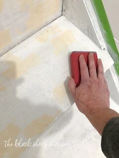 a person using a sponge to paint a wall