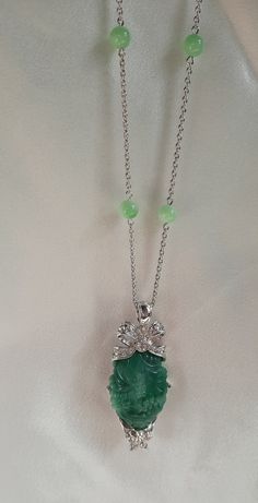 This lovely vintage signed Nolan Miller silver tone pendant necklace features Peking glass beads, sparkling clear Swarovski crystal rhinestones and a large carved faux jade centerpiece. The pendant and silver tone chain are marked Nolan Miller. The necklace is 36 in. L and the pendant is 2-7/8 in. L. This necklace is in very good vintage condition. Elegant Round Jade Crystal Necklaces, Elegant Jade Pendant Crystal Necklace, Sterling Silver Pendant Necklace With Rhinestones, Elegant Crystal Pendant Necklaces, Elegant Crystal Pendant Necklaces With Stones, Elegant Silver Crystal Necklaces With Stones, Elegant Pendant Crystal Necklaces With Rhinestones, Elegant Jade Necklace With Stones, Anniversary Pendant Necklaces With Rhinestones