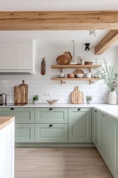 a kitchen with green cabinets and wooden shelves