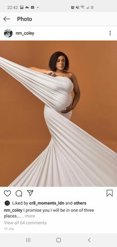 a woman in a white dress posing for a photo on her instagram page with an orange background