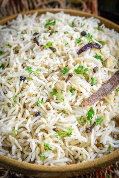 a wooden bowl filled with rice and vegetables