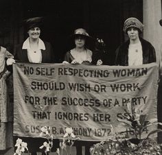 three women standing behind a banner that reads no self respected women should wish - or work for the success of a party