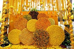 an elaborate arrangement of flowers and decorations for the bride's wedding ceremony in yellow