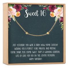 a card saying sweet 16 with roses and gold chains on the front, in a wooden box