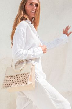 Upgrade your summer look with our cream woven straw statement summer tote! This versatile bag effortlessly takes you from beach days to brunch with ease. Don't miss out on this perfect accessory - shop now! Cream Top Handle Bag With Pearl Detail, Cream Top Handle Bag With Pearl Handle, Cream Rectangular Shoulder Bag With Pearl Handle, White Shopping Bag With Pearl Handle, White Bags With Pearl Handle For Shopping, Natural Color Vacation Bag With Pearl Handle, Natural Vacation Bag With Pearl Handle, Summer Cream Shoulder Bag With Pearl Handle, White Straw Bag With Top Handle