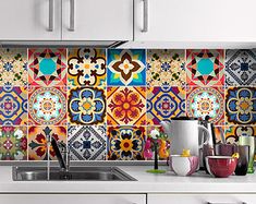 a kitchen with colorful tiles on the wall