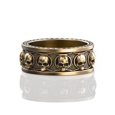 a gold ring with skulls on it