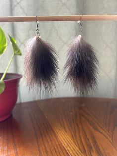 Crafted from genuine beaver fur, these earrings are the perfect accessory for those who appreciate the beauty of the wild. The natural variations in fur patterns make each pair one-of-a-kind. They are ultra-soft and comfortable for all-day wear! This product is handmade in the USA with care and pride. Beaver is ethically sourced in USA. Please message me if you would like coyote, fox, rabbit, raccoon or beaver fur. Earrings can be made to order. Fur Earrings, Fur Accessories, Stylish Earring, Soft Light, Pattern Making, The Wild, Jewelry Earrings Dangle, Dangle Drop Earrings, Dangle Earrings