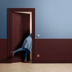 a person is hiding behind an open door in a room with blue and red walls