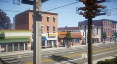 an image of a city street with buildings in the background and power lines above it