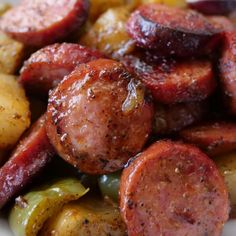 sausages, potatoes and peppers are on a plate