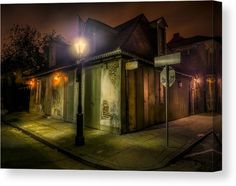 a small building on the side of a street at night