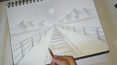 someone is drawing a landscape with pencils