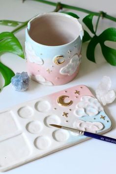 a close up of a paintbrush and cup on a table