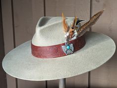 This is the hat! Embossed leather, feathers and a very cool Thunderbird Concho. Bohemian Fur Felt Hat With Adjustable Fit, Flat Crown Fedora For Kentucky Derby, Flat Crown Fedora For Kentucky Derby And Western Events, Brown Southwestern Felt Hat With Curved Brim, Southwestern Brown Felt Hat With Curved Brim, Brown Flat Crown Felt Hat For Country Events, Brown Felt Hat With Flat Crown For Country Events, Flat Crown Felt Hat For Kentucky Derby, Felt Hat For Kentucky Derby With Flat Crown